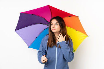 Woman holding an umbrella isolated on white background thinking an idea