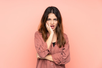 Young caucasian woman isolated on pink background surprised and shocked while looking right