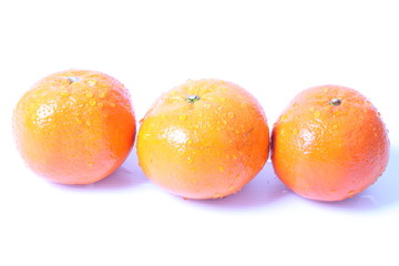 Orange with water drops on a white background