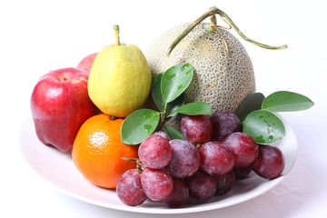 Fototapeta na wymiar Different fruits on white plate