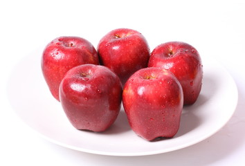 Red apple with water drops isolated on white background.