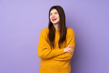 Fototapeta premium Young Ukrainian teenager girl over isolated purple background happy and smiling