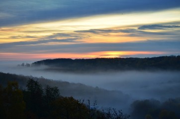 Top view of the foggy forest in the early morning