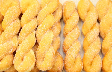 Ready-made donuts covered with powdered sugar on a tray