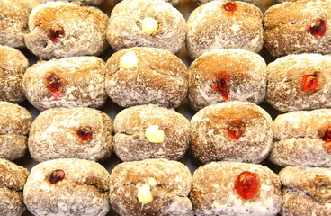 Ready-made donuts covered with powdered sugar on a tray