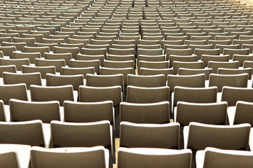 Fototapeta premium A row of empty green seats in a football stadium