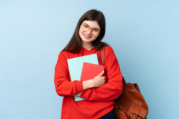 Obraz premium Young Ukrainian teenager student girl holding a salad over isolated blue background