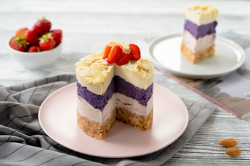  cake with cream and strawberries. Raw dessert with berries. Strawberries and almonds. Layer cake.