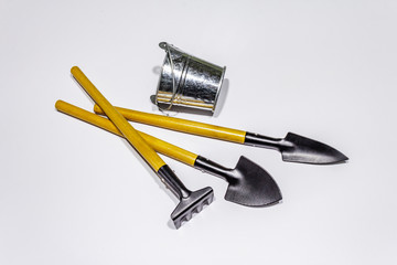 Garden tools isolated on white background. Plant care concept. Shovels, bucket and rake