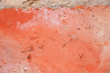 Cracked brown paint close-up. Background from a ragged wall in terracotta color.