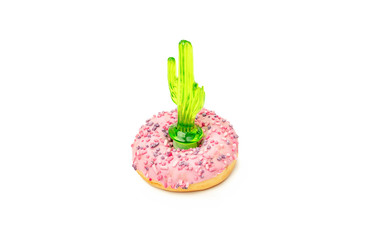 Close up donuts on a bright background. Creative concept junk food. toy cactus.