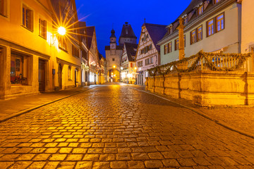 Fototapeta na wymiar Night street with gate and tower Markusturm in medieval Old Town of Rothenburg ob der Tauber, Bavaria, southern Germany