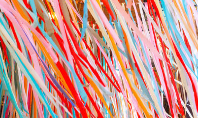 picture of colorful paper strip including red white pink ornage and blue color running down from...