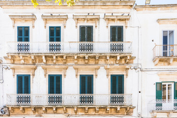 white historical apartments with balcony  in Martina Franca, Italy