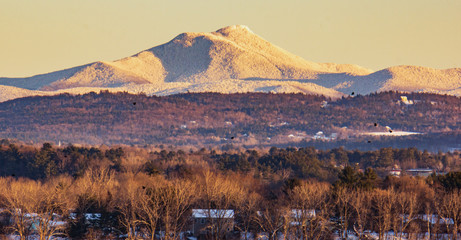 snow covered Camels Hump Mountain in the evening in Vermont