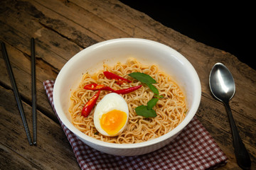 Noodles in a white cup on a wooden table Asian food concept