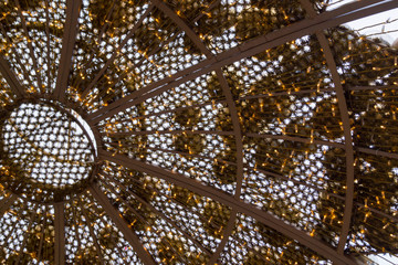 golden balls and grille on the roof of a summer gazebo