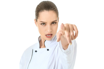 Beautiful female chef pointing at viewer against white background