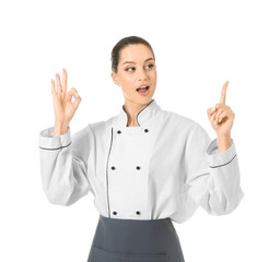 Beautiful female chef with raised index finger showing OK on white background