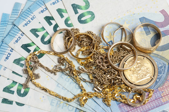Cash for gold, used gold, old jewellery and coins with EU euro banknotes. Selling old or broken gold jewelry to get money