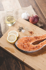 Fresh uncooked salmon on a wooden cutting board. Concept of diet menu and cooking ingredient