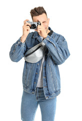 Male tourist with photo camera on white background