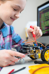 Female Pupil Building Robotic Car In Science Lesson