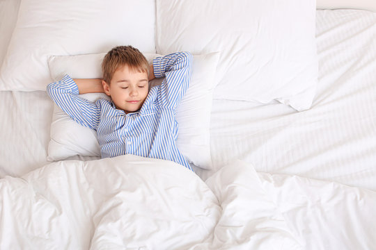 Cute little boy sleeping in bed