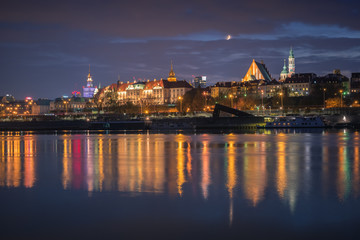 Fototapeta na wymiar Panorama of Warsaw during the moonlit night, Poland