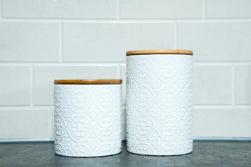 White dishes and a decorative jar. On a blue marble slab. On the kitchen