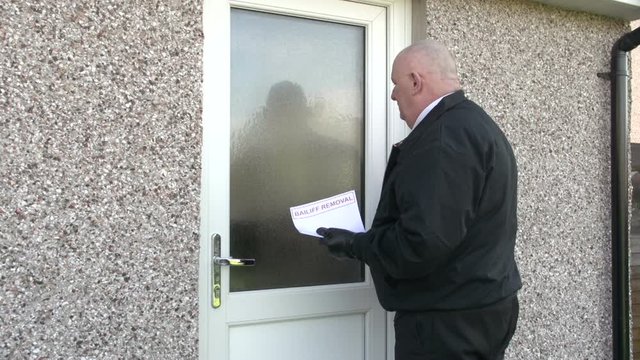 Bailiff / Debt Collector Hands Letter To Woman At Her Home. Repossession. Repo Man. Stock Video Clip Footage.