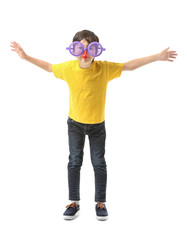 Little boy in funny disguise on white background. April fools' day celebration