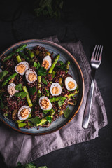 Top view quail eggs red quinoa and asparagus salad moody food photography