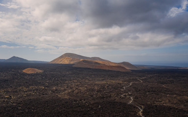 Aerial view of Timanfaya, national park, Caldera Blanca, panoramic view of volcanoes, mountains, vineyards, terrain, wild nature, Lanzarote, Canary Islands, Spain