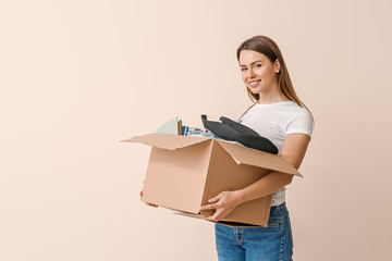 Volunteer with donations for poor people on color background