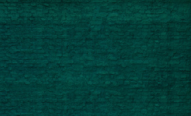 old turquoise brick wall with a thick layer of paint