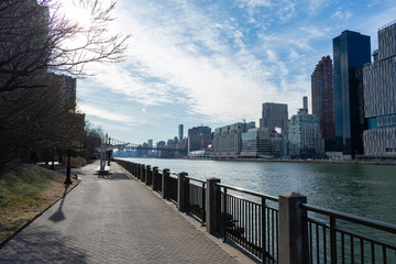 Waterfront along the East River at Roosevelt Island and looking towards the Upper East Side Skyline of New York City