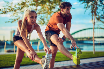 Modern couple doing exercise in urban area.