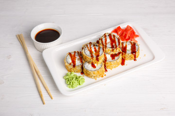 Deep-fried Japanese roll with tiriaki sauce. Traditional Japanese cuisine, menu on a white background