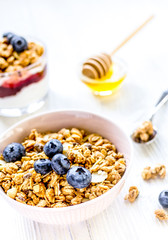 Healthy morning with granola breakfast on white kitchen table