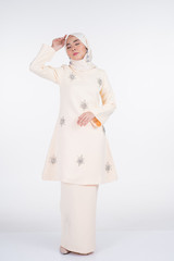 Beautiful female Muslim model in various poses wearing kurung Pahang and hijab, a lifestyle apparel for Muslim women isolated on white. Beauty and hijab fashion concept. Full length portrait