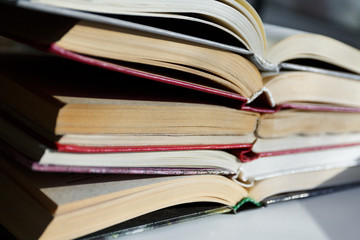 Open books lie on top of each other