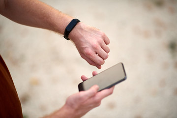 Man using cellphone in urban area at summer time.