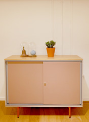 simple modern piece of furniture with plant and ornaments