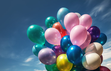 Multi-colored balloons on blue sky background