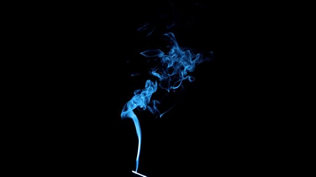 Thin Flexible Trickle of Smoke. Graceful Bends of the Blue Smoke. Natural Colorful smoke rises up and spins into graceful spirals. Footage is perfect for the layer with different blending modes.