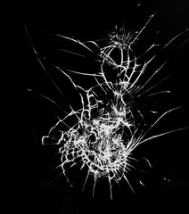 Broken glass with cracks on black background. Blow on the protective glass of the smartphone.