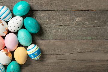 A lot of easter eggs on old wooden background, place for text, top view