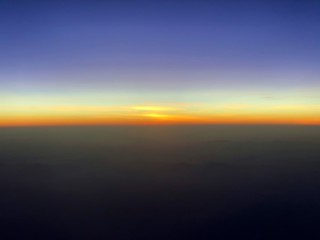 The sun set at the horizon that seen from the airplane