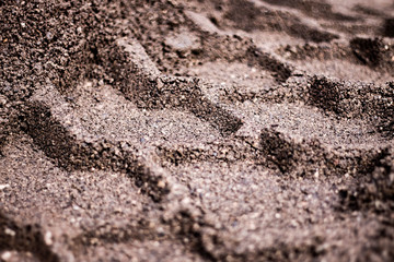 Wheel track in the gravel. Tire tracks in dirt ground. 